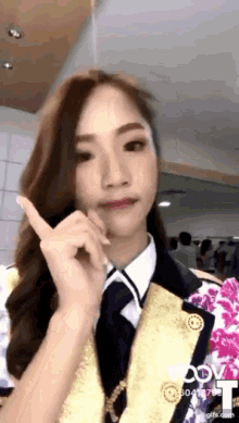 a woman in a military uniform is pointing her finger up