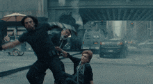 a man and a woman are fighting in front of a van that says wa