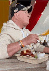 a man is sitting at a table with a tray of food