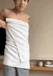 a man is wrapped in a white towel with the hashtag bowen_feng1