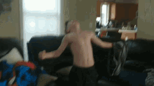 a man without a shirt is dancing on a couch