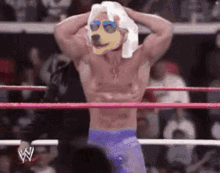 a shirtless wrestler in a wrestling ring with a dog mask on his head .