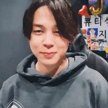 a close up of a person 's face wearing a hoodie and smiling .