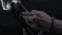 a person 's hand is reaching out towards a bright light