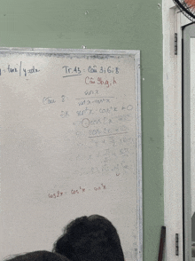 a white board has a math problem written on it in a foreign language