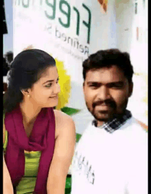 a man and a woman are looking at each other in front of a sign that says 997