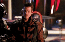 a man in a striped jacket is looking at the camera