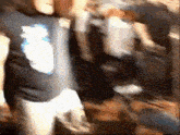 a man in a black shirt with the number 3 on it is dancing in a crowd