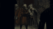 a man with a beard is smoking a cigarette in a dark room