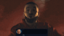 a man in a red shirt is giving a thumbs up next to a go on sign