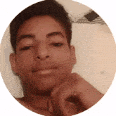 a young man without a shirt is smiling in a circle with his hand on his chin .
