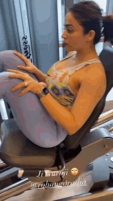 a woman is doing exercises on a machine in a gym