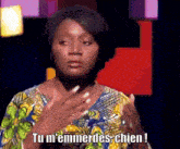 a woman in a floral shirt says tu m ' emmerdes chien !