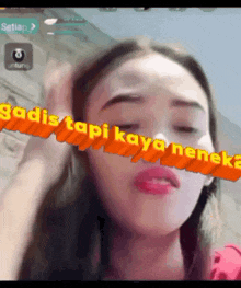 a woman with her eyes closed has the words " gadis tapi kaya nenek " above her face