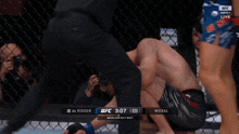 a shirtless ufc fighter stands in front of a cage