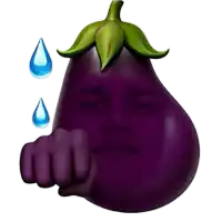 a purple eggplant with a man 's face pointing at the camera