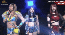 a group of female wrestlers are standing next to each other in front of a stardom logo
