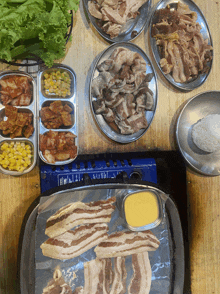 several plates of food on a table including a container of mustard