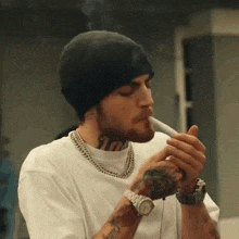 a man wearing a beanie and a watch is smoking