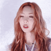 a close up of a woman with red hair and a necklace