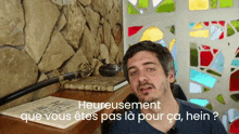 a man stands in front of a stained glass window with the words heureusement que vous êtes pas la pour ca hein