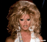 a close up of a drag queen 's face with the tumblr logo in the lower right corner
