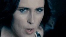 a close up of a woman 's face with a dark background