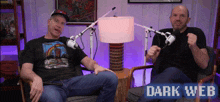 two men are sitting in front of microphones and the words dark web are visible