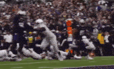a blurred image of a football game with the number 41 on the back of the jersey