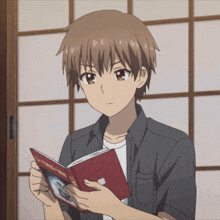 a young anime character is reading a book with chinese writing on it