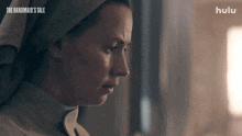 a close up of a woman 's face with the words the handmaid 's tale written on the bottom