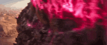 a close up of a person wearing glasses with pink lenses .