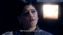 a woman in a striped shirt says we 're just doing our jobs