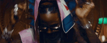 a close up of a person 's face with a hood on