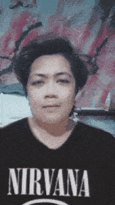 a woman wearing a black nirvana shirt