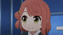 a girl with red hair and green eyes is smiling for the camera