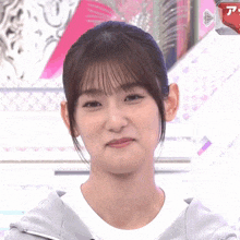 a close up of a woman 's face with the letter a visible in the corner