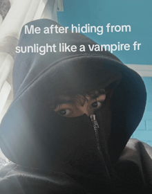a person wearing a black hoodie with the words " me after hiding from sunlight like a vampire fr " on it