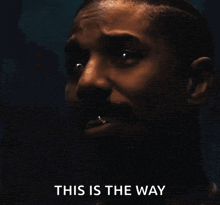 a close up of a man 's face with the words this is the way below him