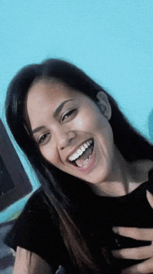 a woman with braces on her teeth smiles with her mouth open