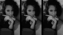a woman is sitting on a couch in a black and white photo .