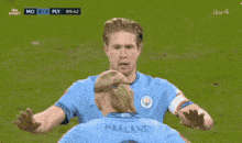two soccer players are on a field and one has the word etihad on his jersey