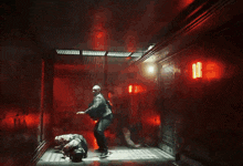 a blurry picture of people walking in a dark room with a red light in the background