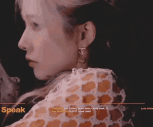 a close up of a woman 's face with the word speak on the bottom right