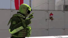 a man in a green helmet is pointing at a stuffed animal on a shelf