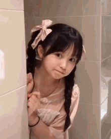 a girl with pigtails and a bow in her hair