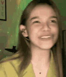 a close up of a woman making a funny face while wearing headphones .