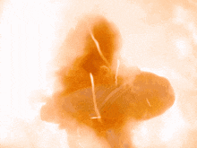 a silhouette of a person in a hoodie is surrounded by flames