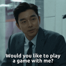 a man in a suit and tie is asking if he would like to play a game with him