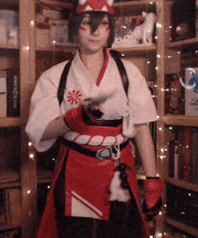 a woman in a red and white costume stands in front of a bookshelf with a box that says ' samurai '